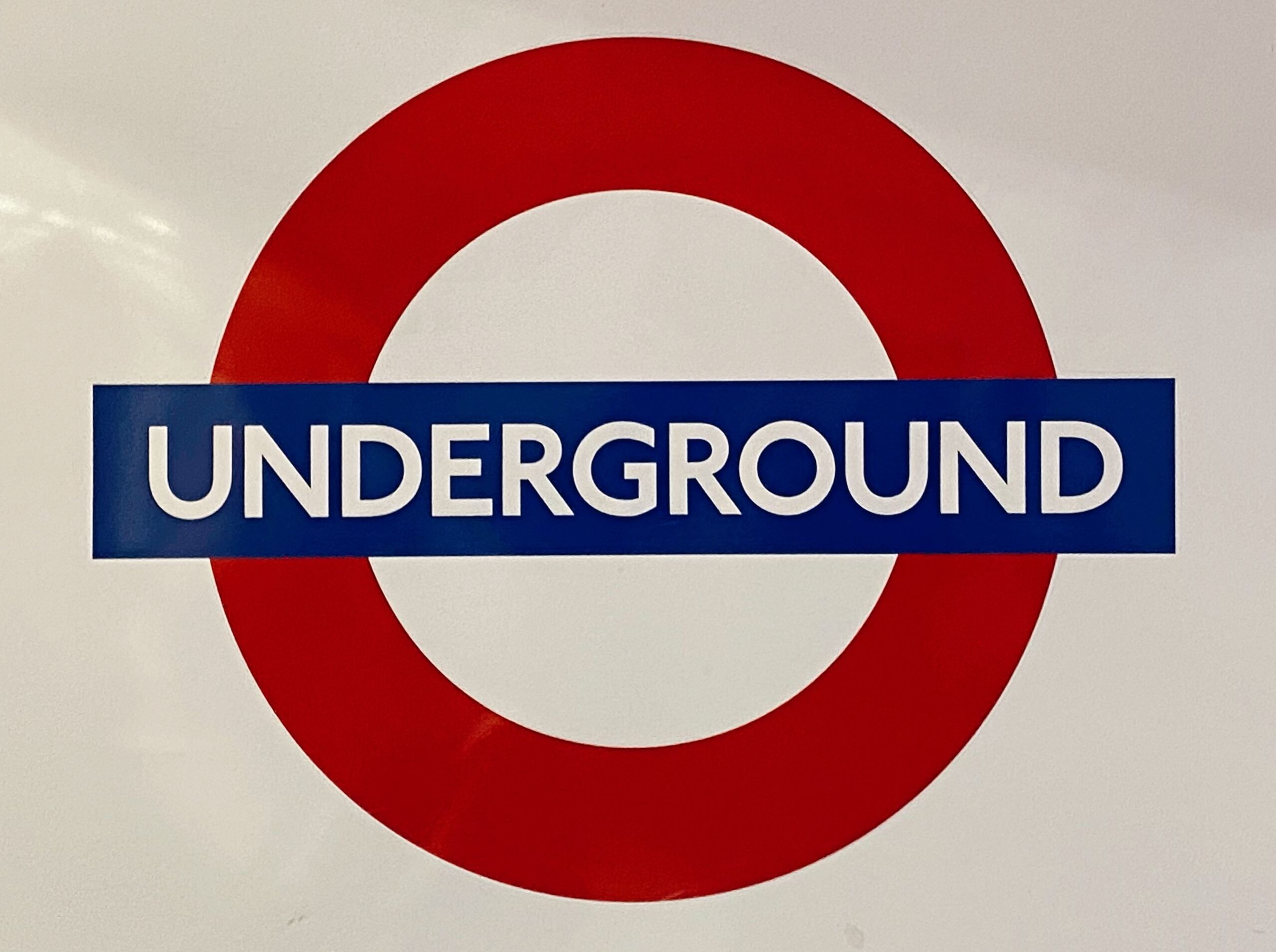 Iconic London Underground logo displayed on a white surface, representing public transport.